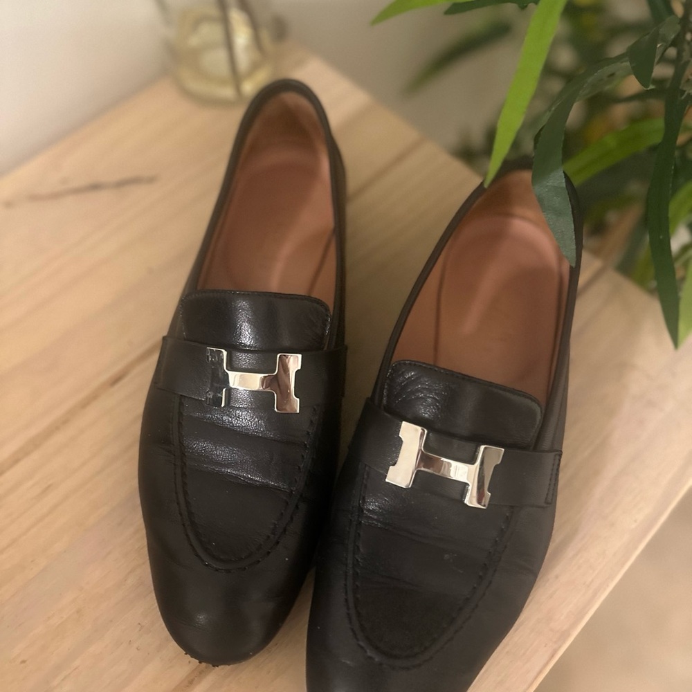 Sold out!
Hermes Black Leather Loafers with Silver Accent